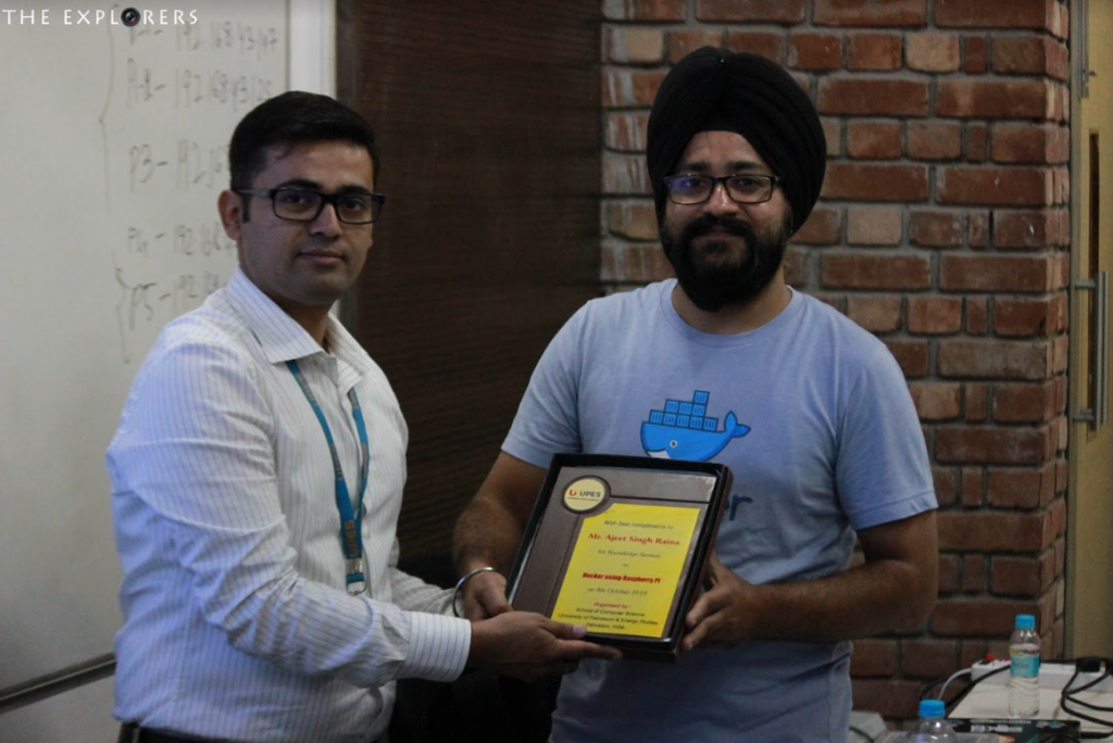UPES faculty presenting a memento to Docker Captain Ajeet Singh Raina