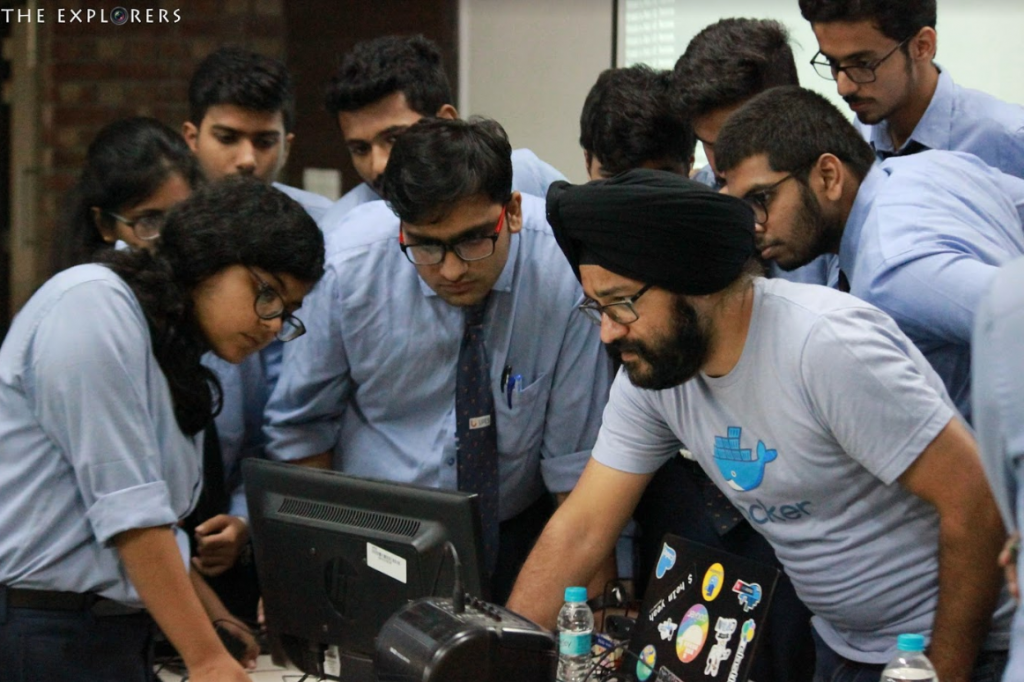 Students gathered around a laptop during the Docker workshop at UPES Dehradun